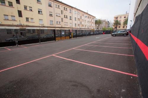 an empty parking lot with a car parked in it at Hotel Borgia in Gandía