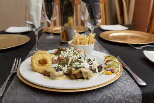 a plate of food and french fries on a table at Augrabies Falls Lodge & Camp in Augrabies