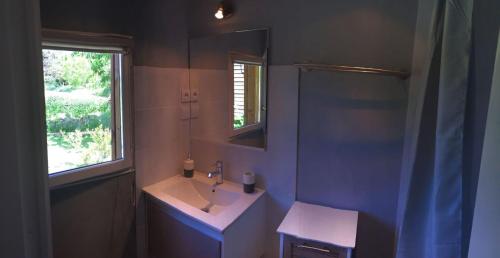 a bathroom with a sink and a mirror at Chambres d'Hôtes L'Ardiegeoise in Ardiège