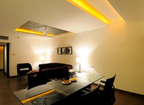 a living room with a couch and a table at The Central Court in Hyderabad