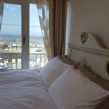 a bedroom with a bed with a view of the ocean at HANI Haus in Jeju