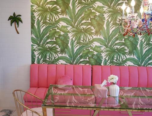a pink couch in a living room with a table at HANI Haus in Jeju