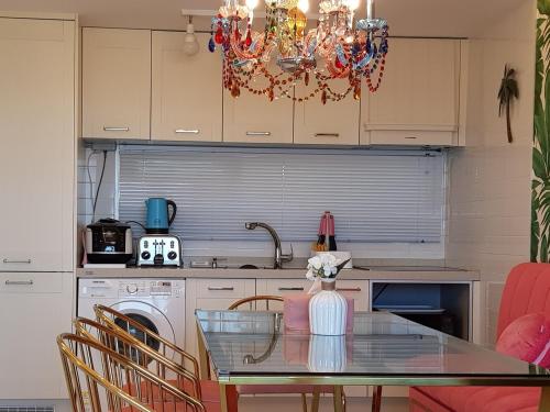 a kitchen with a glass table and a dining room at HANI Haus in Jeju