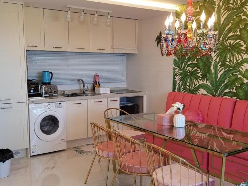 a kitchen with a table and a red couch at HANI Haus in Jeju
