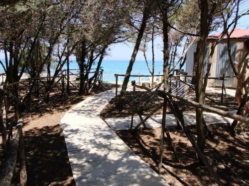 a path along the beach with the ocean in the background at Rosa Marina Frontline Beach in Ostuni