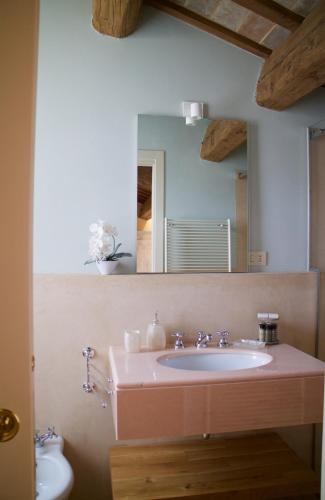 a bathroom with a sink and a mirror at Le Case Di San Vitale Easy in Ravenna