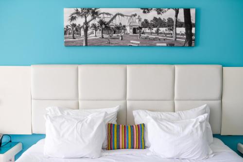 a black and white photo of a bed with white pillows at Aquashow Park Hotel in Quarteira