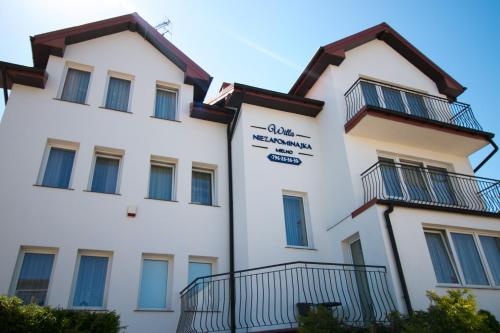 a building with balconies on the side of it at Willa Niezapominajka Mielno in Mielno