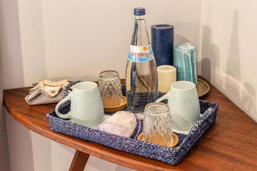 a table with a bottle and glasses on it at Casas da Formosa - Downtown Alegria in Tavira