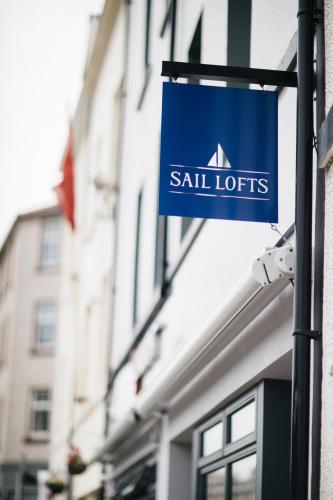 a blue sign on the side of a building at Sail Lofts in Douglas