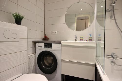 a bathroom with a washing machine and a sink at ARC 1800 Pierra Menta in Arc 1800