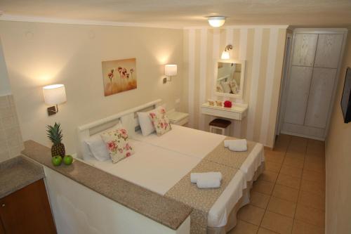 a room with a white table in a kitchen at Blue Sky Apartments in Malia