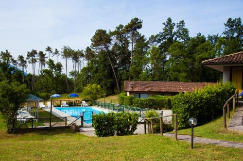 a swimming pool in a yard with a roller coaster at Residence Tourist in Lucca