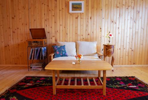 a living room with a table and a couch at Rivendell in Borjomi