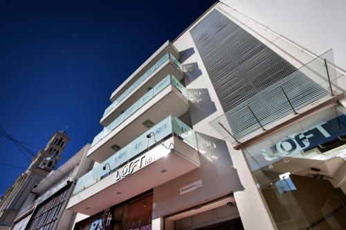 a building with a sign on the side of it at Loft Hotel in Pasto