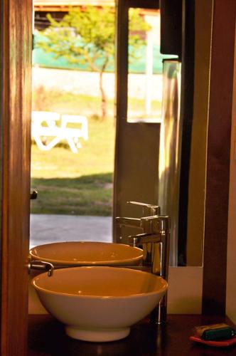 a bathroom with a bowl sink and a mirror at Complejo Retana in Potrero de los Funes