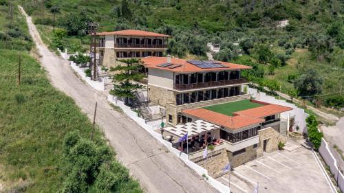 an aerial view of a building with a tennis court at Corali Hotel in Kymi