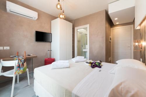 Ένα ή περισσότερα κρεβάτια σε δωμάτιο στο Isule Rooms & Breakfast