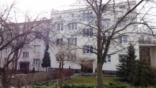 a white building with trees in front of it at Sopot Mirrors in Sopot