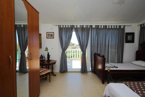 a bedroom with a bed and a window with curtains at Lola's Apartments in Tribunj