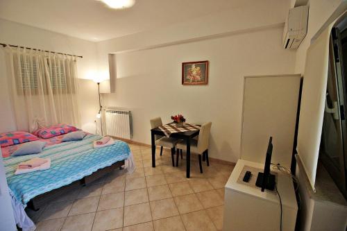 1 dormitorio con cama, mesa y escritorio en Studio in Porec/Istrien 9882, en Poreč