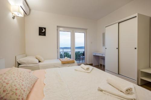 Postel nebo postele na pokoji v ubytování Apartmani Kristijan