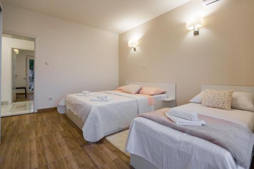 Postel nebo postele na pokoji v ubytování Apartmani Kristijan