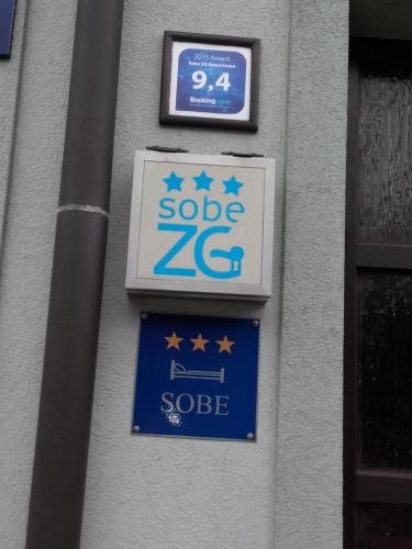 a sign on the side of a building with stars on it at Rooms Sobe ZG in Zagreb