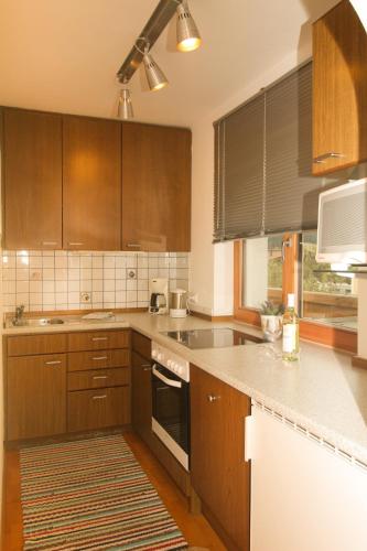 a kitchen with wooden cabinets and a stove top oven at Apartment Anita in Ellmau
