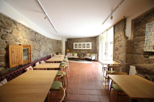 a row of tables and chairs in a restaurant at Quinta de Lourosa in Lousada