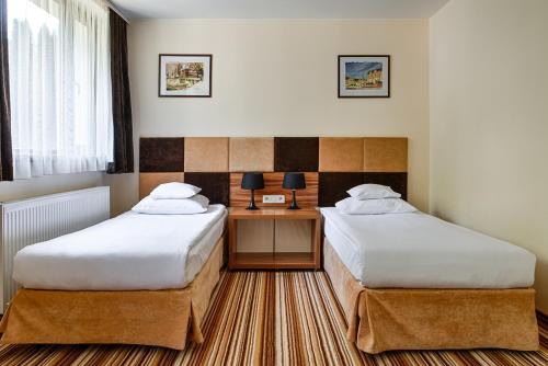 Postel nebo postele na pokoji v ubytování Boutique Hotel's Kwiska - Legnicka