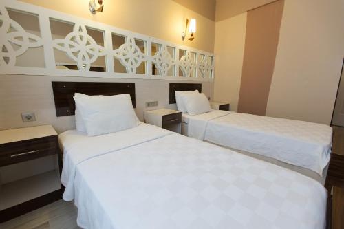Postel nebo postele na pokoji v ubytování Ozbay Hotel