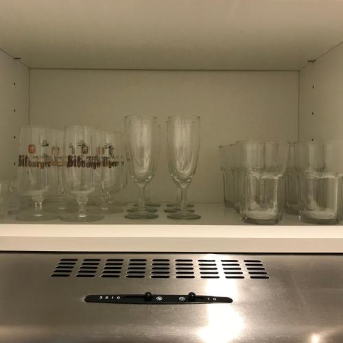 a row of wine glasses sitting on a shelf at Hotel Select Suites & Aparts in Mönchengladbach