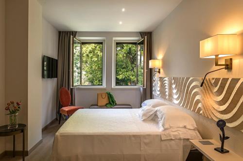 Ένα ή περισσότερα κρεβάτια σε δωμάτιο στο Hotel Laurin