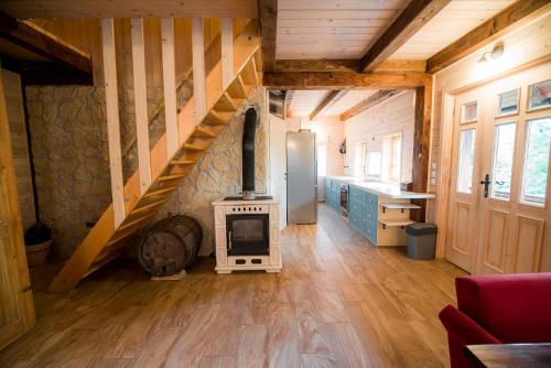 a living room with a stove and a staircase at Sunny House with Sauna in Bistrica ob Sotli