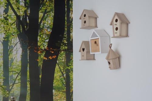 a group of birdhouses hanging on a tree at HCR Prinsen in Haarlo
