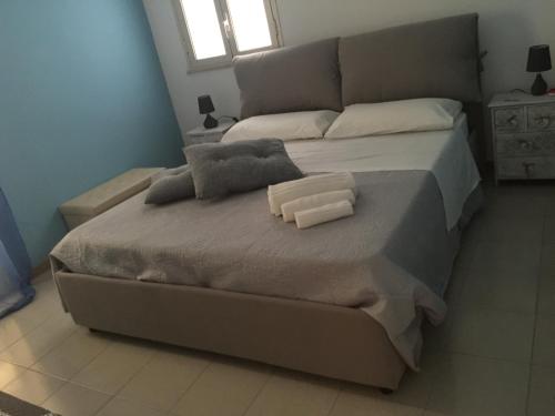 a large bed with two pillows on it in a bedroom at Villa Priscilla in Cinisi