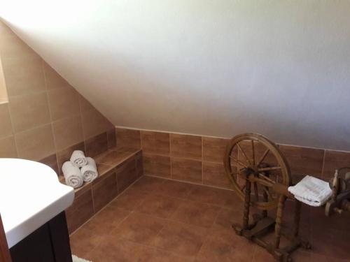 a bathroom with a shower with a wheel and towels at apartman-bartko in Banská Štiavnica