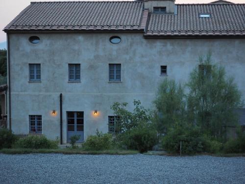a large stone house with a roof at Podere San Niccola in Punta Ala