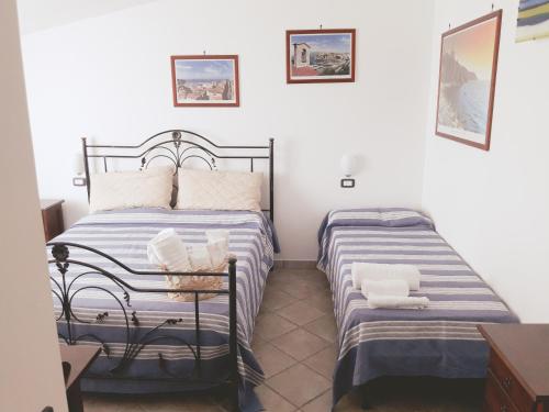 a bedroom with two beds in a room at B&B La Civetta in Agropoli