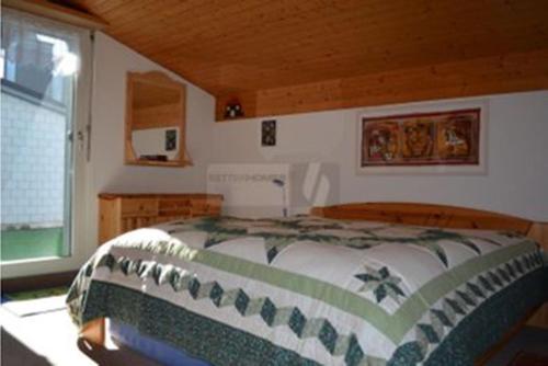 a bedroom with a bed in a room with a window at Haus Alvier - CharmingStay in Flumserberg
