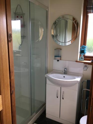 a bathroom with a sink and a shower at Old Mills Garden in Elgin