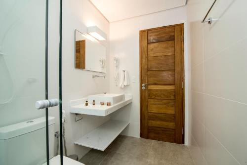 a bathroom with a sink and a mirror at Pousada Todas as Luas in Ubatuba