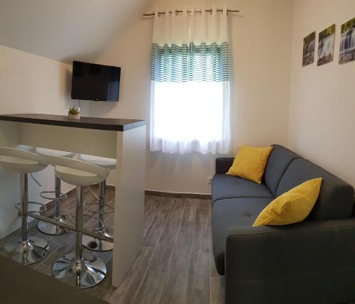 a living room with a couch and a table at Apartment Prijeboj Plitvice Lakes in Prijeboj