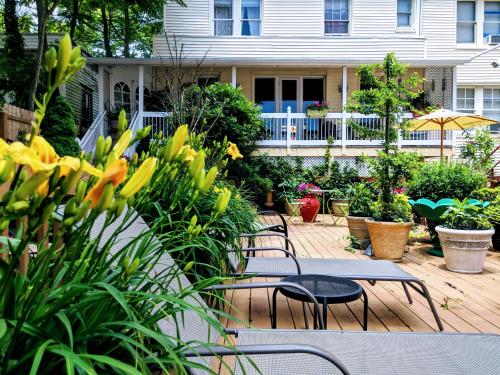 a patio with tables and chairs in front of a house at Chelsea Pub and Inn in Atlantic City