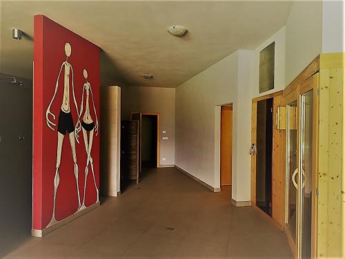 an empty hallway with a large painting on the wall at Pension Apartments Klotznerhof in Schenna