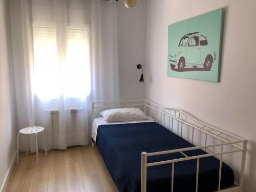a bedroom with a bed with a blue blanket and a window at Caputxins Apartment in Tarragona