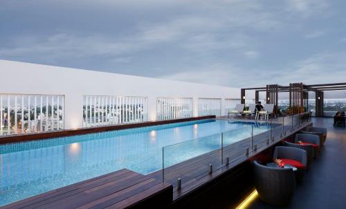 a large swimming pool on the top of a building at Novotel Chennai Chamiers Road in Chennai