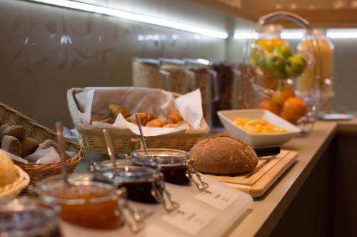 a table with bread and baskets of food on it at Hotel Wetterstein in Munich