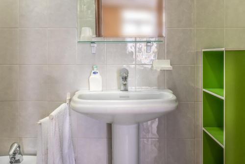a bathroom with a white sink and a mirror at Residence Daniele in Bellaria-Igea Marina
